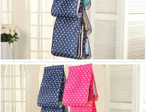 Detailed view showing the polka dot pattern of the hanging bag organizer for closet storage
