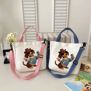 Two cute canvas tote bags featuring dachshund embroidery in pink and blue colors