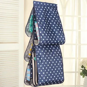 Durable blue hanging handbag organizer with white polka dots for closet storage