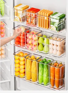 Transparent refrigerator side door storage bins filled with fresh fruits and vegetables