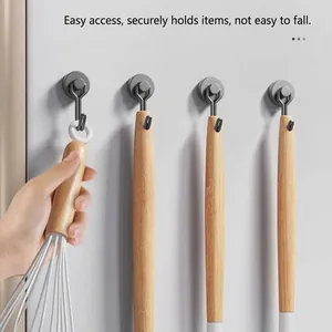 Strong magnetic kitchen hooks on refrigerator side with wooden utensils hanging