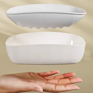 Minimalist white double-layer drainage soap dish for bathroom with hand for scale