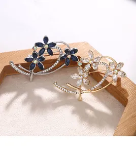 Detailed view of elegant floral brooches with shimmering blue and clear crystals