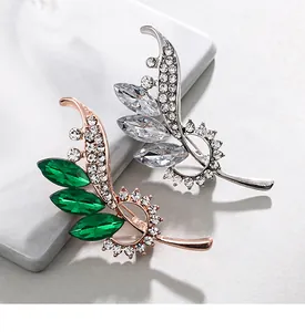 Elegant leaf-shaped crystal brooches featuring green and silver stones for women