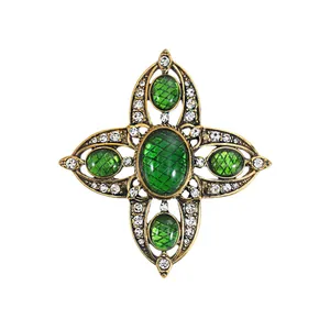 Vintage hollow cross brooch with green emerald stones and rhinestones for suits.