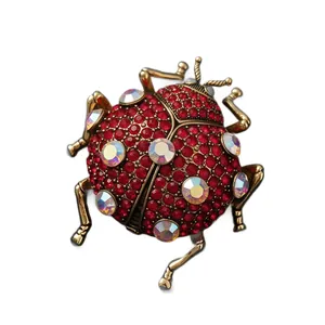 Vintage ladybug brooch with red rhinestones and iridescent crystals for suit jacket