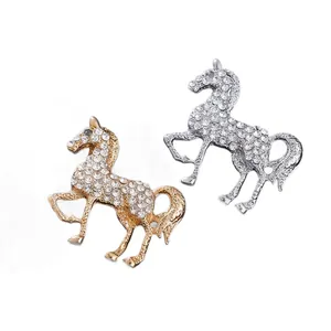 Elegante paardvormige broches met sprankelende strass-steentjes in goud en zilver