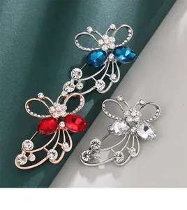 Detailed view of three crystal butterfly brooches with rhinestones in various colors