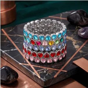 Elegant alloy bracelets with multi-color heart-shaped crystals stacked on marble