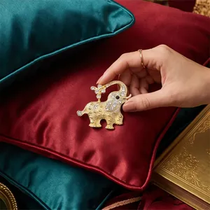Elegant golden alloy elephant brooch with sparkling rhinestones for suit decoration