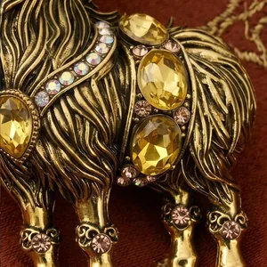 Macro view of vintage alloy goat brooch with yellow rhinestones and antique gold finish