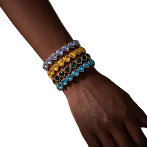 Set of four colorful heart-shaped crystal bracelets displayed on a model's wrist in high detail