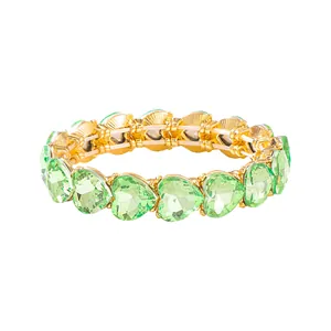Elegant gold-tone stretch bracelet featuring light green faceted crystal hearts.