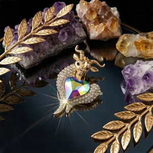 Elegant gold-toned goat brooch featuring a vibrant heart-shaped crystal and rhinestones.