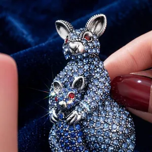 Vintage kangaroo mother and baby brooch with sparkling blue rhinestones on velvet.