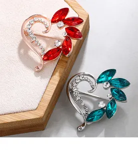Detailed macro shot of heart-shaped crystal brooches featuring elegant rhinestone flower petals