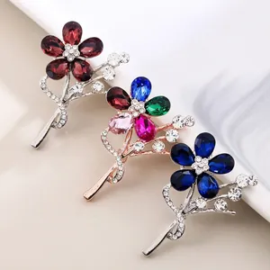 Elegant set of three colorful crystal flower brooches featuring sparkling rhinestone details.