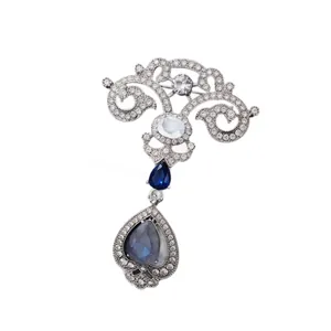 Vintage court style teardrop brooch with blue crystals and silver filigree pin