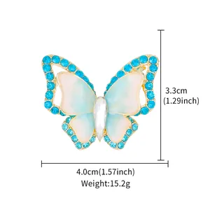 Elegant butterfly brooch with blue crystals and gold-tone finish for suits 4.0x3.3cm