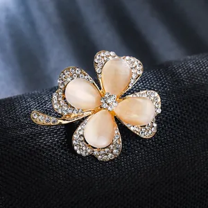 Elegant four-leaf clover brooch with cat's eye stones and rhinestones detail