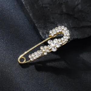 Elegant gold-tone alloy safety pin brooch with sparkling rhinestone flower motifs