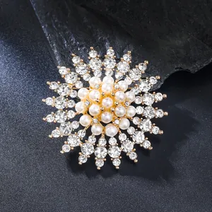 Detailed macro shot of an elegant gold pearl and rhinestone sunflower brooch pin. Perfect detail.