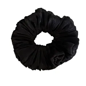 Elegant black pleated shimmering fabric hair scrunchie for women's fashion bun styles