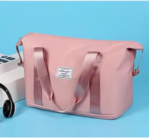 Large pink foldable travel duffel bag for women displayed with lifestyle lifestyle props