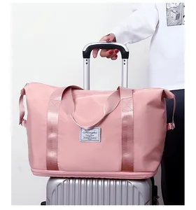 Pink large capacity travel duffel bag mounted on a silver luggage suitcase handle