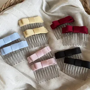 Detailed view of colorful satin bow hair combs in pink, blue, red, and cream.