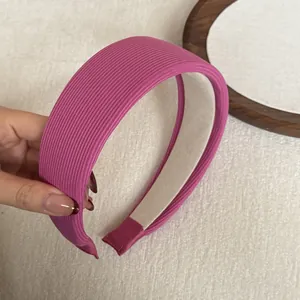 Close-up of pink wide sponge headband showing ribbed fabric texture and soft lining
