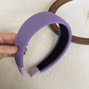 Detail of purple ribbed wide-brimmed sponge headband with soft texture
