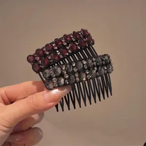 Close-up detail of two elegant sparkling rhinestone hair comb clips in maroon and smoky grey