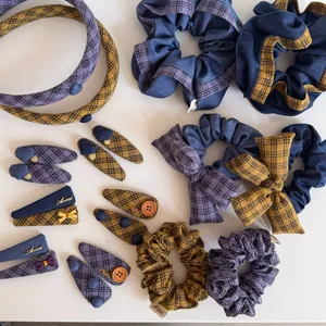 Detail view of purple and yellow plaid hair scrunchies and clips set