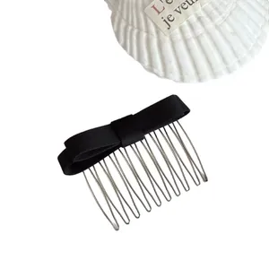 Elegant black satin bow hair insert comb for women hair styling on white background