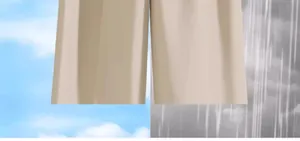 Detail view of beige trousers hanging outdoors in both sunny and rainy conditions