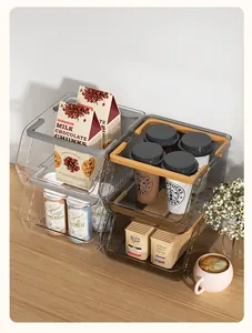 Large stackable clear plastic storage bins for snacks and drinks in a modern workspace