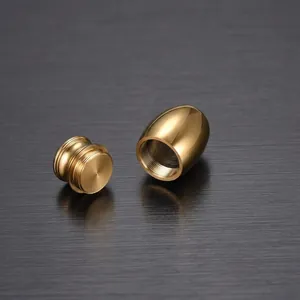 Macro detail of small golden metallic pet cremation urn showing secure screw closure