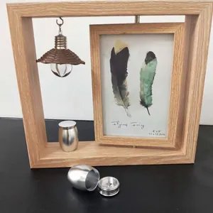 Rotating wooden 4x6 photo frame set with small silver keepsake cremation urns for ashes