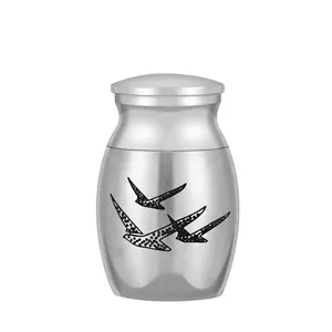Detailed view of silver stainless steel cremation urn featuring elegant flying bird design