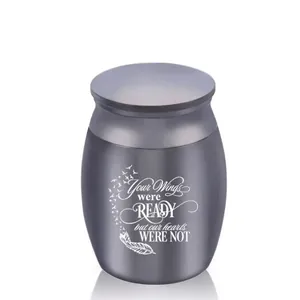 Detail of pet cremation urn with engraved wings and sentimental message