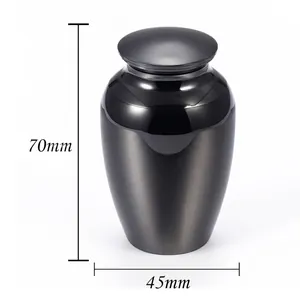 Small metallic cremation urn with dark gray finish, height 70mm and width 45mm.