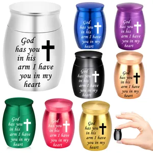 Mini cremation urns for pets or humans with engraved cross and heart message closeup