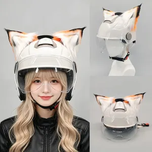 Detailed view of white and orange movable fox ears attached to motorcycle helmet
