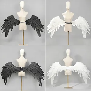 Large black and white angel wings cosplay props shown on mannequins for stage performance