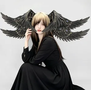 Intricate gothic black glitter seraph wing hair accessory with gold chains and jewels