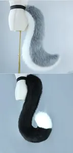 Detail view of plush faux fur animal tails in grey and black for fursuit cosplay.