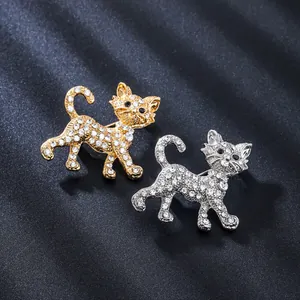 Detail view of cat-shaped alloy brooches with sparkling rhinestones in gold and silver finish