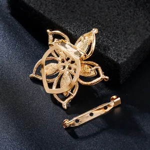 Detailed macro view of the gold alloy flower brooch back structure and separate safety pin