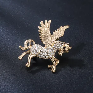 Close-up detail of a golden Pegasus brooch adorned with many sparkling rhinestones